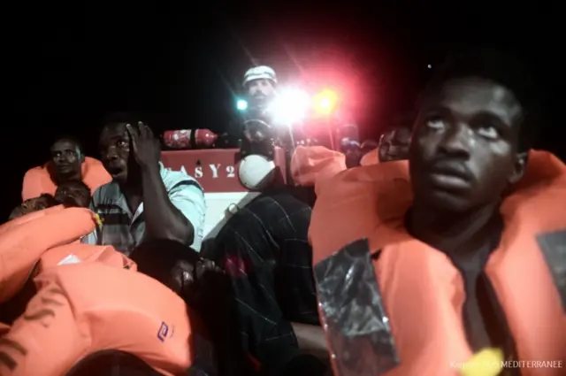 A handout picture taken in the search and rescue zone in the Mediterranean sea on June 9, 2018 and released on June 11, 2018 by SOS Mediterranee NGO shows migrants being rescued before boarding the French NGO"s ship Aquarius