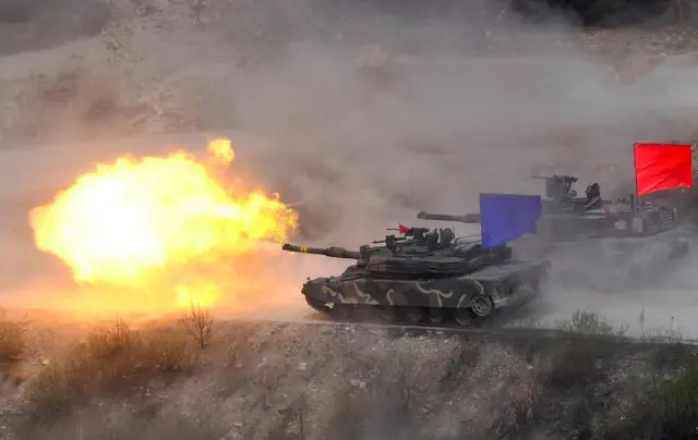 This picture taken on April 21, 2017 shows South Korean K1A2 tanks firing live rounds during a media day presentation of a joint live firing drill between South Korea and the US at the Seungjin Fire Training Field in Pocheon, 65 kms northeast of Seoul