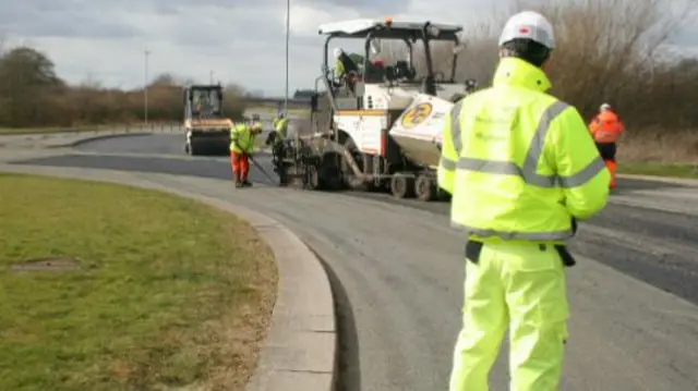 Workmen working on a road