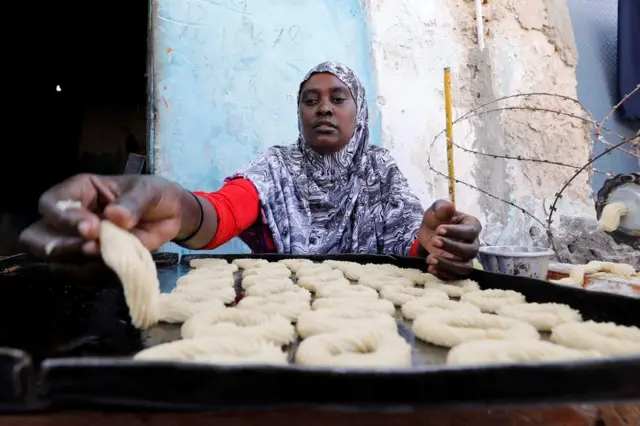 A Somali woman prepares traditional cakes and biscuits at a bakery in Mogadishu, Somalia