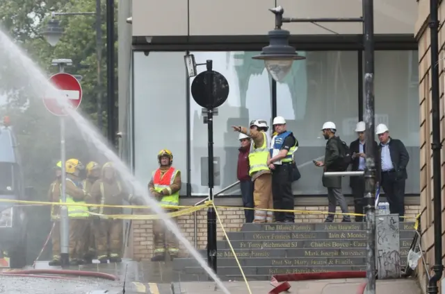 First Minister Nicola Sturgeon (purple jacket) views the damage following the fire at the historic Mackintosh Building in Glasgow