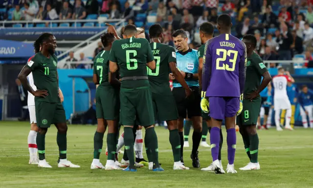 Nigeria players remonstrate after referee Sandro Ricci