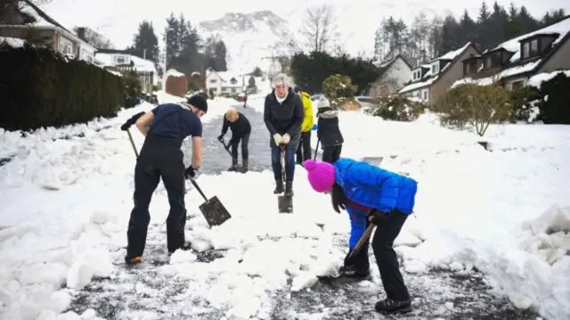 People clearing snow