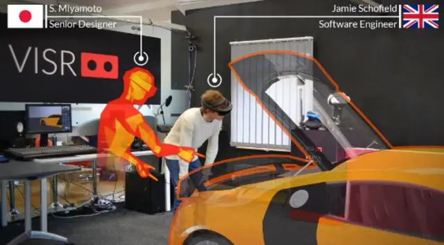 A man being shown how to repair a car in a virtual world.