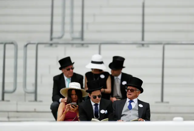 Racegoers sitting in the stands at Royal Ascot