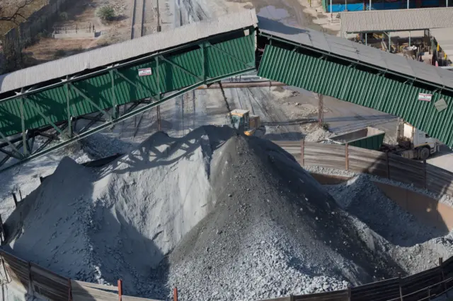 Copper ore is transported on a belt and dropped in a pile before being picked up by trucks for processing at Mopani mines on July 6, 2016 in Mufulira, Zambia