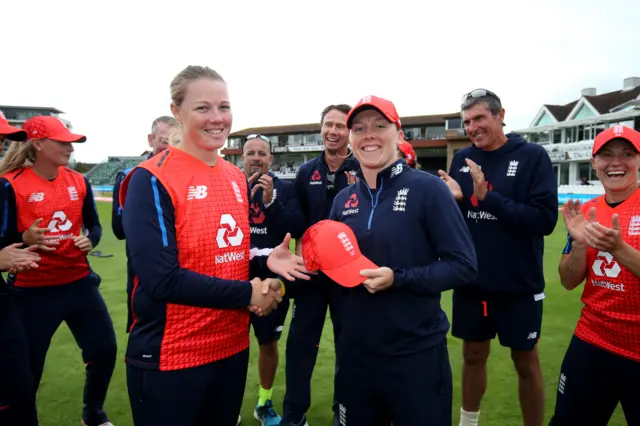 Heather Knight of England (R) presents Anya Shrubsole with her 50th T20 cap