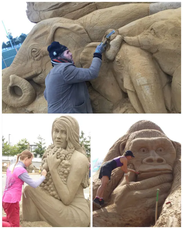 Artists sculpting elephants, a gorilla and a mermaid.