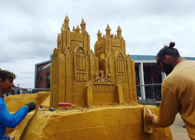 Sculptors making a small replica of Beverley Minster.