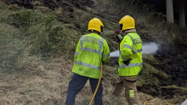 The grass fire being tackled