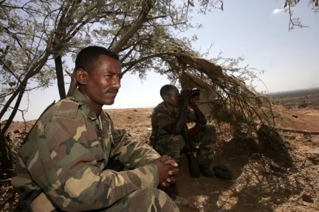 Ethiopian soldiers take advantage of the shade of a tree 20 November 2005 on a hilltop outpost overlooking the northern Ethiopian town of Badme, in the Tigray region