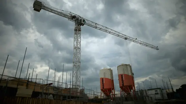 Crane operates above housing estate