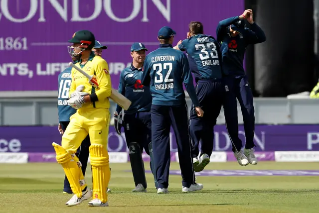 England players celebrate taking the wicket of Australia's Marcus Stoinis