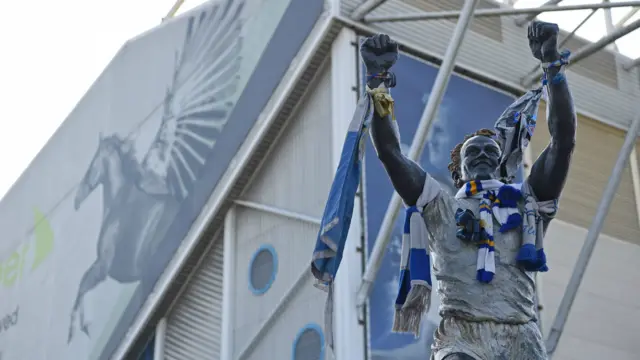 The statue of Leeds United legend Billy Bremner, adorned with scarves, is pictured outside the ground ahead of the International friendly football match between England and Costa Rica at Elland Road, Leeds in northern England on June 7, 2018.