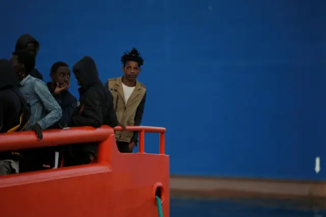 Migrants, part of a group intercepted aboard three dinghies off the coast in the Mediterranean Sea, stand on a rescue boat upon arrival at the port of Malaga, Spain June 18