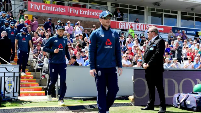 Eoin Morgan leads out the England player's