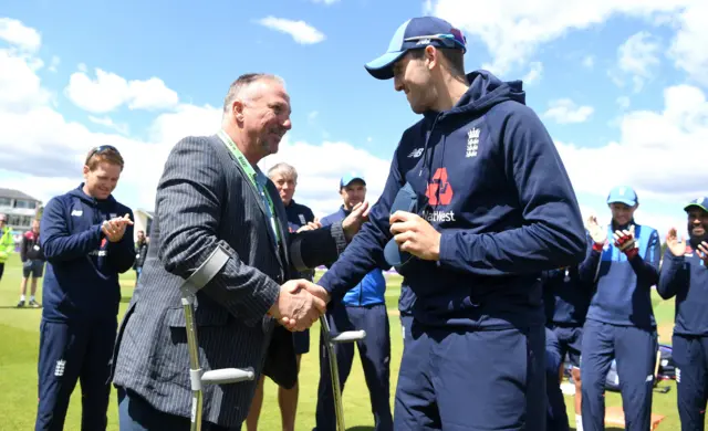 Craig Overton of England is presented his cap by Sir Ian Botham