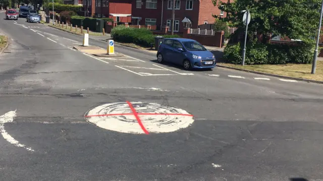 Roundabout with red cross