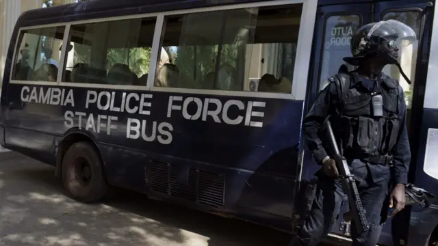 Gambian police officers stand guard outside the Supreme Court of Gambia after an opposition leader was freed on bail along with 18 others in Banjul on December 5, 2016