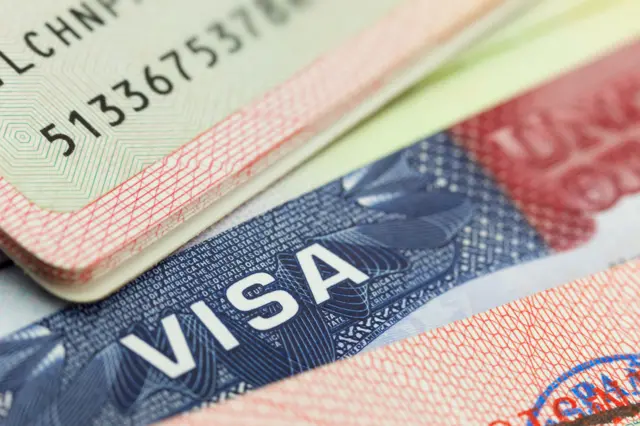 A close-up shot of a passport with US visa