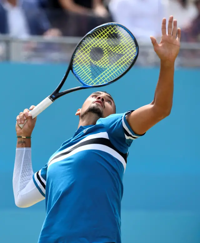 Kyrgios serves during the first set