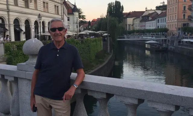 Laurence Downey wearing sunglasses standing by a canal