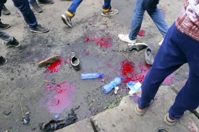 Pools of blood are seen on the ground as people gather at the scene of an explosion during a massive rally to support the new reformist prime minister Abiy Ahmed in Meskel Square in Addis Ababa, Ethiopia, 23 June 2018