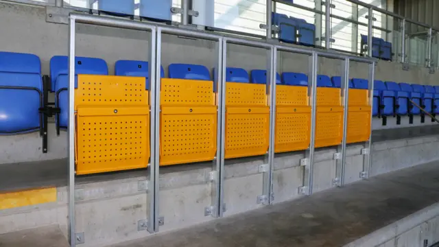 Yellow rail seats in Shrewsbury stadium