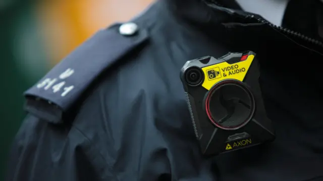 body-worn camera on a police officer's left shoulder