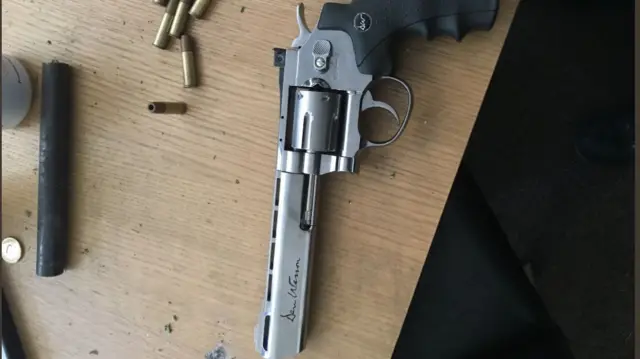 The gun on the table with bullets nearby