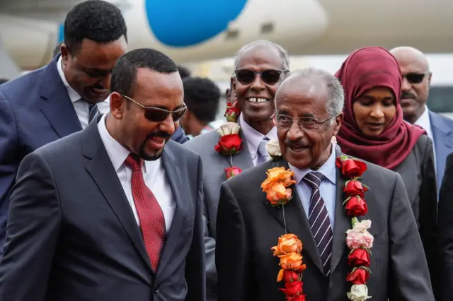 Ethiopia's Prime Minister Abiy Ahmed (L) walks with Eritrea's Foreign minister Osman Saleh Mohammed (R)