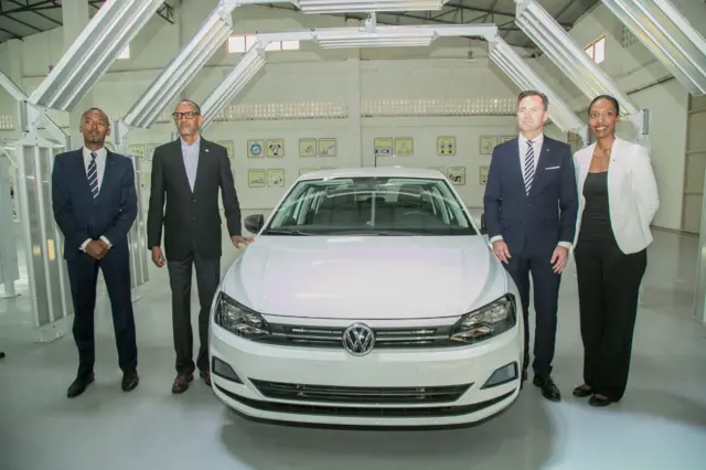 Rwanda's President Paul Kagame (2nd L) poses with Volkswagen Group South Africa CEO Thomas Schafer (2nd R),