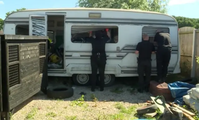 Police raiding a caravan