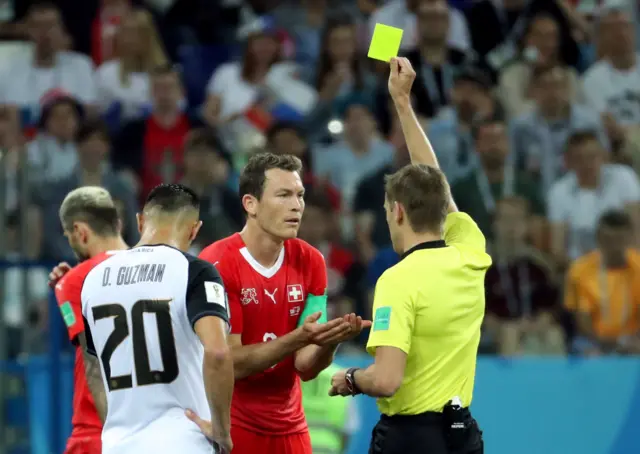 Switzerland's Stephan Lichtsteiner receives yellow card