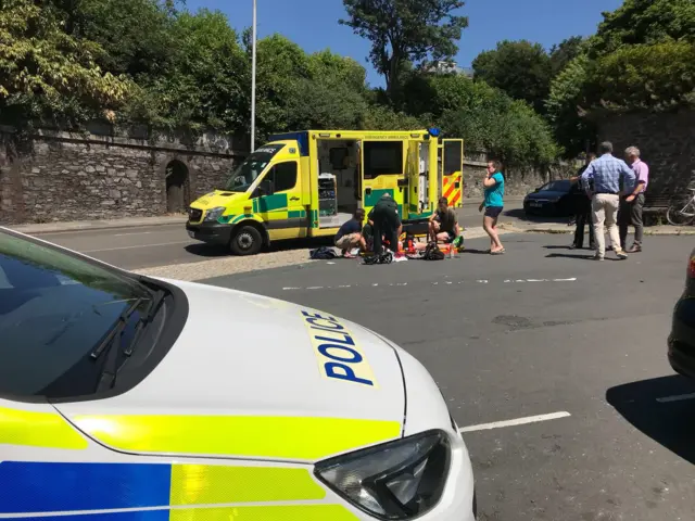 ambulance staff treating a patient at the road side