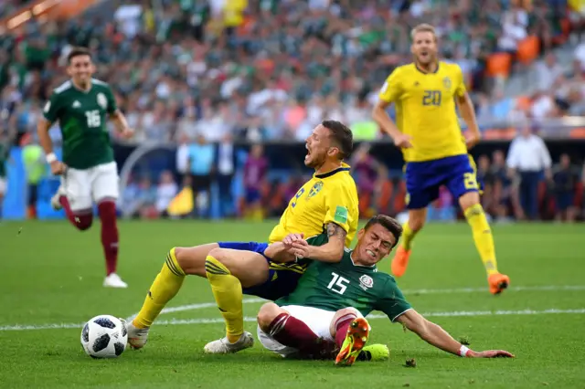 Hector Moreno of Mexico fouls Marcus Berg of Sweden