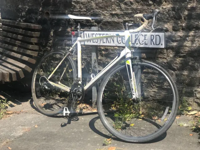 bike in front on road sign