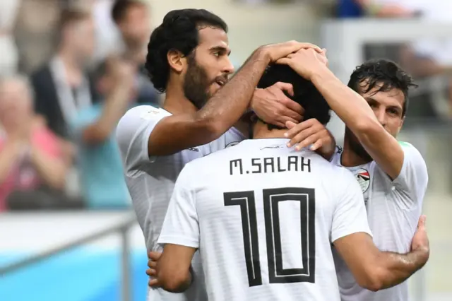 Mohamed Salah (front) is congratulated by teammates after scoring during the Russia 2018 World Cup Group A football match between Saudi Arabia and Egypt at the Volgograd Arena in Volgograd on June 25, 2018