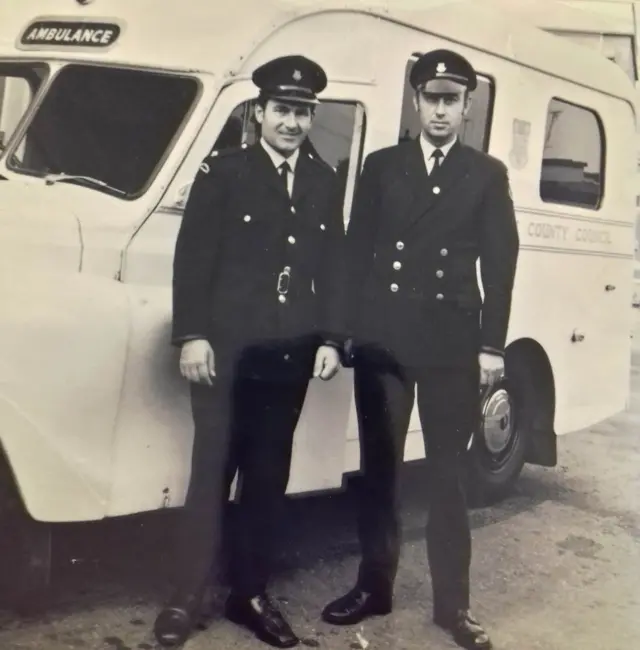 Ron (on the right) with the station officer stood in front of an Austin Princess ambulance in 1975