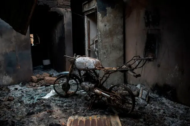 The frame of a burnt out motorcycle is seen in a house burned down by Fulani herdsman in the Ganaropp village in the Barikin Ladi area near Jos on June 27, 2018