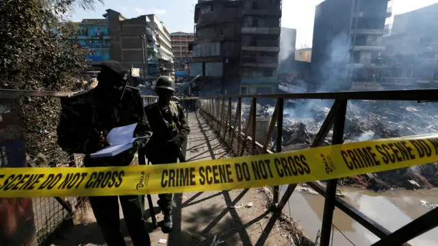 Officers at the scene of the fire at Gikomba market, Nairobi, Kenya - 28 June 2018