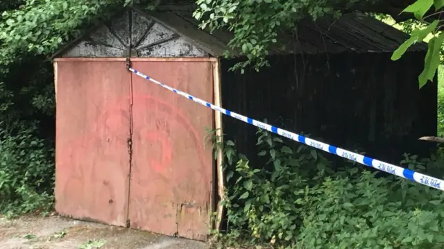 Shed with police tape attached