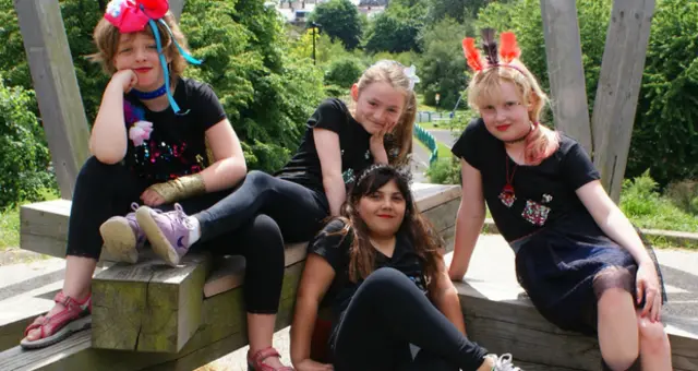 Four girls, from one of the groups, pose for photos