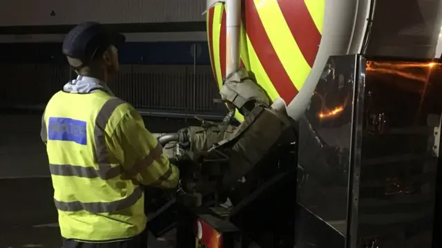 Worker putting water into system