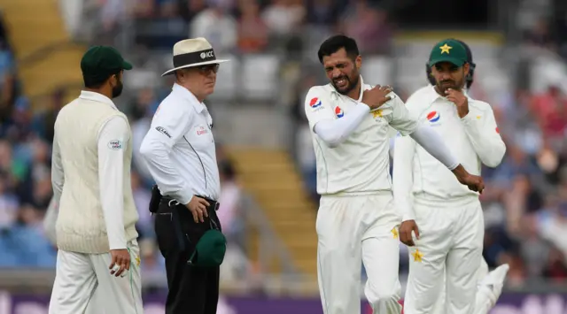 Mohammad Amir clutches his left shoulder