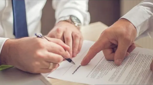 Person signing contract