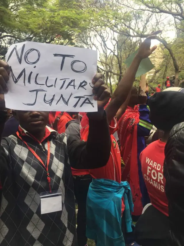 Supporters of Zimbabwe's opposition MDC party demonstrate with banners