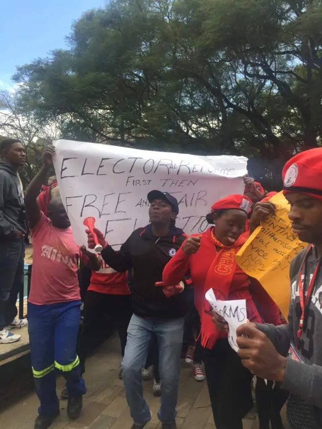 Supporters of Zimbabwe's opposition MDC party demonstrate with banners