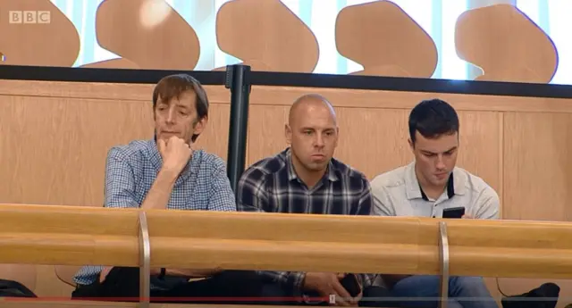 Tim Hopkins from the Equality Network, on the left, is applauded by MSPs