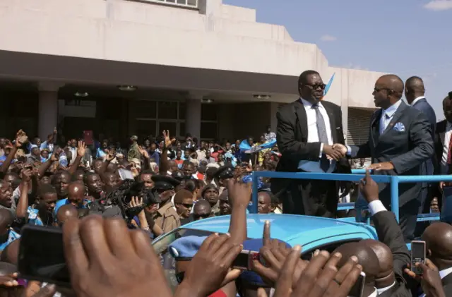 Peter Mutharika (2nd R), a young brother of the former late President Bingu wa Mutharika, and his Deputy Saulos Chilima (R) greet supporters after taking an oath of office at the High Court on May 31, 2014, in Blantyre, Malawi